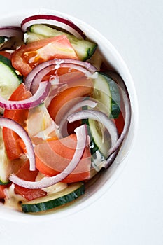 Vegetable salad cucumber tomato with sunflower oil. on the white background. isolated