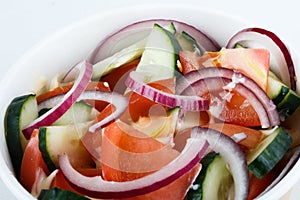 Vegetable salad cucumber tomato with sunflower oil. on the white background. isolated