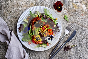 Vegetable salad with edible flowers