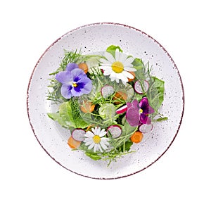 Vegetable salad with edible flowers on white background