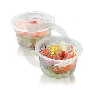 Vegetable salad in the food storage box on white