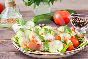 Vegetable salad of fresh cucumbers, tomatoes and parsley