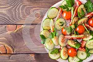 Vegetable salad of fresh cucumbers, tomatoes and parsley