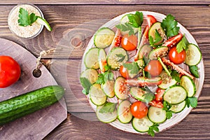 Vegetable salad of fresh cucumbers, tomatoes and parsley