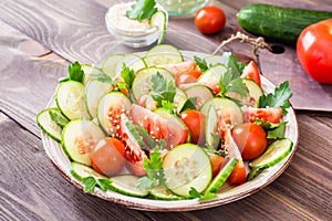 Vegetable salad of fresh cucumbers, tomatoes and parsley