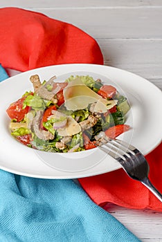 Vegetable salad with roasted meat and cheese. Italian cuisine concept, healthy eating.