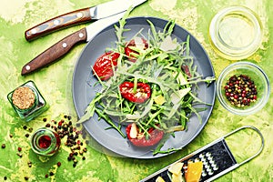 Vegetable salad with sun-dried tomato and arugula,top view