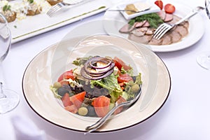 Vegetable salad on a white plate on the table