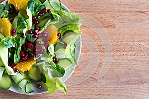Vegetable salad on a wooden background with copy space, top view