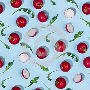 Vegetable seamless pattern of radish and arugula with shadow in hard light on blue background.