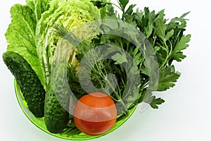 Vegetable set in deep green bowl on light background