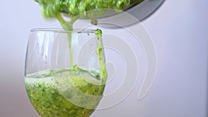 Vegetable smoothie, freshly squeezed celery juice poured from blender into glass