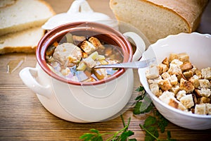 Vegetable soup with beans and meatballs in a ceramic bowl