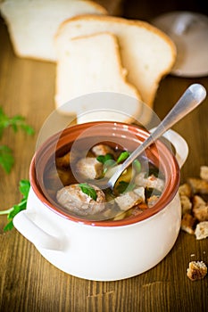 Vegetable soup with beans and meatballs in a ceramic bowl