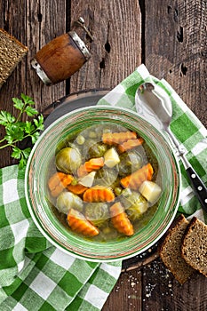 Vegetable soup with brussel sprouts on wooden rustic table