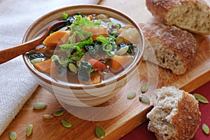 Vegetable soup in ceramic bowl with bread