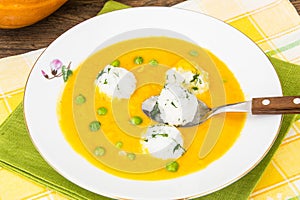 Vegetable soup cream with pumpkin, rice and green peas