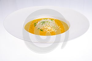 Vegetable soup with grated cheese isolated on white background.