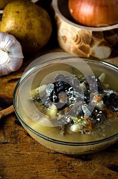 Vegetable soup mushrooms glass bowl rustic