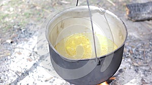Vegetable soup outdoors in a cauldron