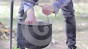 Vegetable soup outdoors in a cauldron