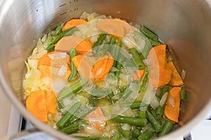 Vegetable soup in the pan in the kitchen on the stove. Dinner time