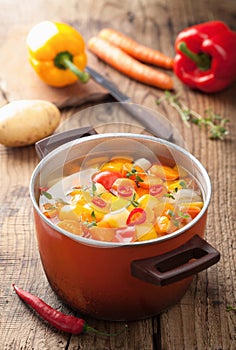 Vegetable soup in red pot