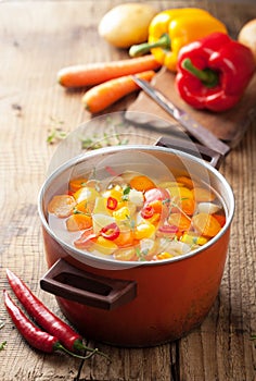 Vegetable soup in red pot