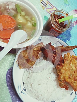 Vegetable soup, rice, chicken wing and hot spicy sauce for prepare eating