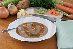 Vegetable Soup on Table with Ingredients