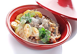 Vegetable stew with meat,mushroom and herbs on a white background