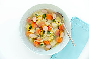 Vegetable Stew with Sliced Sausage in Blue Soup Bowl