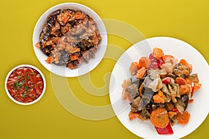 Vegetable stew on a white plate. stewed vegetables on a colored background. vegetarian food