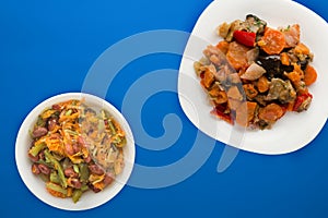 Vegetable stew on a white plate. stewed vegetables on a colored background. vegetarian food