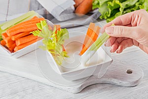 Vegetable sticks. Fresh celery and carrot with yogurt sauce. Healthy and diet food concept