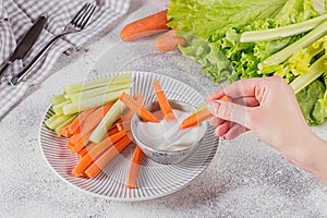 Vegetable sticks. Fresh celery and carrot with yogurt sauce. Healthy and diet food concept