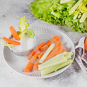 Vegetable sticks. Fresh celery and carrot with yogurt sauce. Healthy and diet food concept