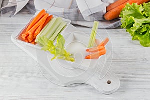 Vegetable sticks. Fresh celery and carrot with yogurt sauce. Healthy and diet food concept