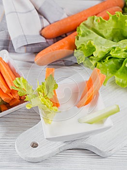 Vegetable sticks. Fresh celery and carrot with yogurt sauce. Healthy and diet food concept