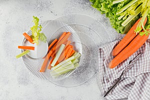 Vegetable sticks. Fresh celery and carrot with yogurt sauce. Healthy and diet food concept