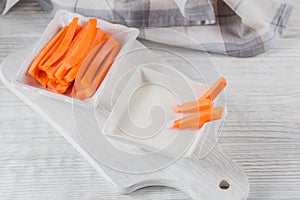 Vegetable sticks. Raw carrot with yogurt sauce. Healthy and diet food concept