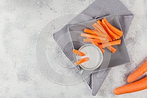 Vegetable sticks. Raw carrot with yogurt sauce. Healthy and diet food concept