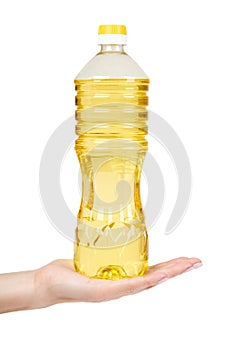 vegetable or sunflower oil in plastic bottle with hand isolated on white background