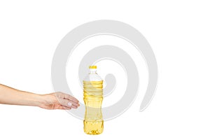 vegetable or sunflower oil in plastic bottle with hand isolated on white background, copy space template