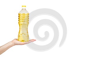 vegetable or sunflower oil in plastic bottle with hand isolated on white background, copy space template