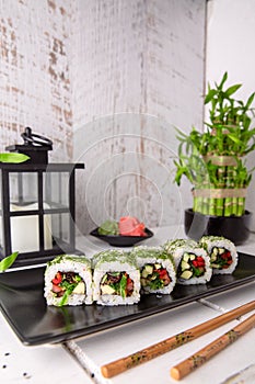 Vegetable sushi rolls on a black plate. Sushi menu.