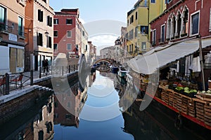 Vegetable vendor`s barge on canal in Venice Italy photo