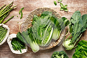 Vegetables background. Various vegetables in a basket on kitchen table. Clean eating, healthy food concept
