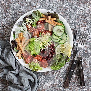 Vegetables, beans, avocado and cheese salad on a light background, top view. Delicious appetizer