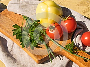 Vegetables on a blackboard, tomato and green onions on a wooden